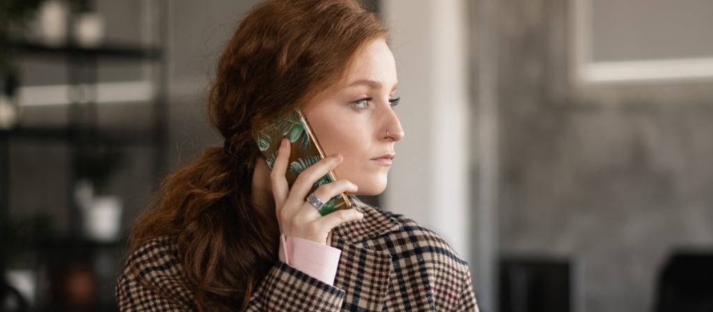Customer listening to on hold messages while waiting on a phone call
