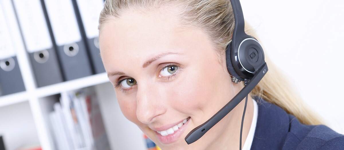 Female contact centre worker wearing a headset.
