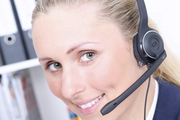 Female contact centre worker wearing a headset.